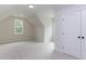 Bright bonus room featuring plush carpet, neutral paint and great natural light from two large windows at 25 Alex Farm Ct, Zebulon, NC 27597