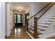 Elegant entryway featuring hardwood floors, a staircase, and natural light at 25 Alex Farm Ct, Zebulon, NC 27597