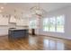 Modern kitchen with white cabinets, a gray island, and stainless-steel appliances at 25 Alex Farm Ct, Zebulon, NC 27597