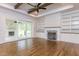 Spacious living room featuring custom built-ins, fireplace and outdoor access at 25 Alex Farm Ct, Zebulon, NC 27597