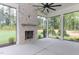 Cozy screened porch with a brick fireplace and large windows overlooking the backyard at 25 Alex Farm Ct, Zebulon, NC 27597