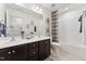 Bathroom featuring double sinks, a large mirror, a shower-tub combination, and modern fixtures at 27 Cribbs Ln, Middlesex, NC 27557
