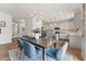 Dining area open to the kitchen featuring a stylish chandelier, hardwood floors, and white walls at 27 Cribbs Ln, Middlesex, NC 27557