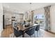 Dining area open to the kitchen with a view to the patio and featuring a stylish chandelier and hardwood floors at 27 Cribbs Ln, Middlesex, NC 27557