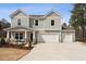 Charming two-story home featuring a spacious two-car garage and a welcoming front porch with stone accents at 27 Cribbs Ln, Middlesex, NC 27557