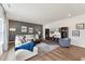 Comfortable living room with a large sectional sofa, textured accent wall, and modern entertainment center at 27 Cribbs Ln, Middlesex, NC 27557