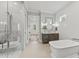 Bright bathroom featuring a glass enclosed shower with built-in bench, a soaking tub, and modern fixtures at 285 Mollie Meadow Dr, Zebulon, NC 27597