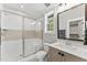 Bright bathroom with a glass-enclosed shower, a large mirror, and a view into the walk-in closet at 285 Mollie Meadow Dr, Zebulon, NC 27597