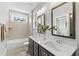 A bright bathroom features double sinks, modern fixtures, and a separate shower and bathtub at 285 Mollie Meadow Dr, Zebulon, NC 27597