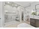 A modern bathroom features a spacious shower, elegant tile work, and a view into the walk-in closet at 285 Mollie Meadow Dr, Zebulon, NC 27597