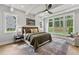 Bright bedroom boasts a decorative ceiling fan, stylish rug, and lots of natural light from the large windows at 285 Mollie Meadow Dr, Zebulon, NC 27597