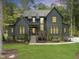 Stunning two-story home with a lush lawn, stone accents, and mature trees at 285 Mollie Meadow Dr, Zebulon, NC 27597