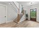 Inviting foyer with hardwood floors and a staircase with iron spindles at 285 Mollie Meadow Dr, Zebulon, NC 27597
