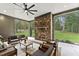 Covered patio with a stone fireplace, comfortable seating, and views of the backyard at 285 Mollie Meadow Dr, Zebulon, NC 27597