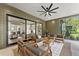 Inviting covered patio with comfortable seating, ceiling fan, and sliding glass doors at 285 Mollie Meadow Dr, Zebulon, NC 27597