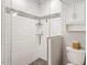Clean bathroom showcases a glass-enclosed shower with white tiling and stone accents at 2913 Anderson Dr, Raleigh, NC 27608