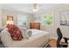 Bright bedroom features hardwood floors, a ceiling fan, and a large window view at 2913 Anderson Dr, Raleigh, NC 27608