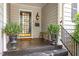 Inviting front porch with decorative plants, stylish lighting, and house number 2913 at 2913 Anderson Dr, Raleigh, NC 27608
