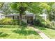 Charming single-story home with a beautiful lawn and lush landscaping at 2913 Anderson Dr, Raleigh, NC 27608