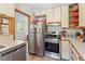 Well-lit kitchen features stainless steel appliances, ample cabinet storage and modern countertops at 2913 Anderson Dr, Raleigh, NC 27608
