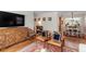 Open living room featuring hardwood floors, comfortable seating, and a decorative wooden cabinet at 2913 Anderson Dr, Raleigh, NC 27608