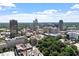 Scenic aerial view of the cityscape featuring various buildings, lush greenery, and a vibrant blue sky with scattered clouds at 317 W Morgan St # 320, Raleigh, NC 27601