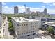Elevated view of building exterior with city skyline in background on a sunny day at 317 W Morgan St # 320, Raleigh, NC 27601