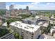 Elevated view of building exterior with city skyline and tree tops in the background at 317 W Morgan St # 320, Raleigh, NC 27601