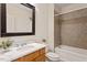 Cozy bathroom with tile surround tub and shower, wood cabinets and large mirror at 317 W Morgan St # 320, Raleigh, NC 27601