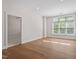 A spacious bedroom with hardwood floors and a large window at 317 W Morgan St # 320, Raleigh, NC 27601