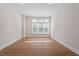 A bright and airy bedroom with hardwood floors and large windows at 317 W Morgan St # 320, Raleigh, NC 27601