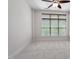 This bedroom has a ceiling fan and large window with natural light and neutral carpet at 317 W Morgan St # 320, Raleigh, NC 27601