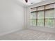 Cozy bedroom featuring a neutral carpet, natural light, and a ceiling fan at 317 W Morgan St # 320, Raleigh, NC 27601