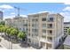 Multi-story building exterior with light beige facade, balconies, and landscaping at 317 W Morgan St # 320, Raleigh, NC 27601