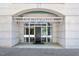 Welcoming entrance to The Dawson with a black door, large windows, and stone facade at 317 W Morgan St # 320, Raleigh, NC 27601