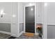 Apartment entryway with a gray door, welcome mat, and floral arrangement at 317 W Morgan St # 320, Raleigh, NC 27601