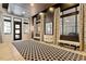 Elegant hallway featuring patterned carpeting, sconce lighting, and neutral paint at 317 W Morgan St # 320, Raleigh, NC 27601
