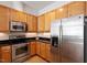 Modern kitchen with stainless steel appliances, wooden cabinetry, and ample counter space at 317 W Morgan St # 320, Raleigh, NC 27601