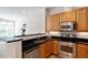 Well-equipped kitchen with stainless steel appliances and wooden cabinets at 317 W Morgan St # 320, Raleigh, NC 27601