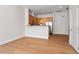 Open-concept living area with hardwood floors and a modern kitchen at 317 W Morgan St # 320, Raleigh, NC 27601