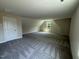 Spacious bedroom featuring a patterned carpet, bright natural light, and neutral wall colors at 322 Busterfield Ct, Benson, NC 27504