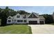 Beautiful new construction home featuring two-tone siding and a three-car garage at 322 Busterfield Ct, Benson, NC 27504