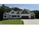Newly built house with a modern design, beautiful siding, and an attached garage at 322 Busterfield Ct, Benson, NC 27504