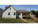 Two story home with vinyl siding, a covered porch, and green grass at 322 Busterfield Ct, Benson, NC 27504