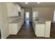 Spacious kitchen with white cabinets, granite countertops, and a stainless steel sink at 322 Busterfield Ct, Benson, NC 27504