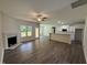 Large living room with a fireplace, ceiling fan, and open access to the kitchen at 322 Busterfield Ct, Benson, NC 27504