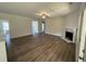 Open living room with a ceiling fan, wood floors, a fireplace, and lots of space at 322 Busterfield Ct, Benson, NC 27504
