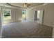 Spacious main bedroom featuring carpet floors, two windows and ensuite bath access at 322 Busterfield Ct, Benson, NC 27504