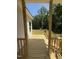 Relaxing covered porch with wood flooring and railings, perfect for enjoying the outdoors at 322 Busterfield Ct, Benson, NC 27504