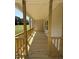 Relaxing covered porch with wood flooring and railings, perfect for enjoying the outdoors at 322 Busterfield Ct, Benson, NC 27504